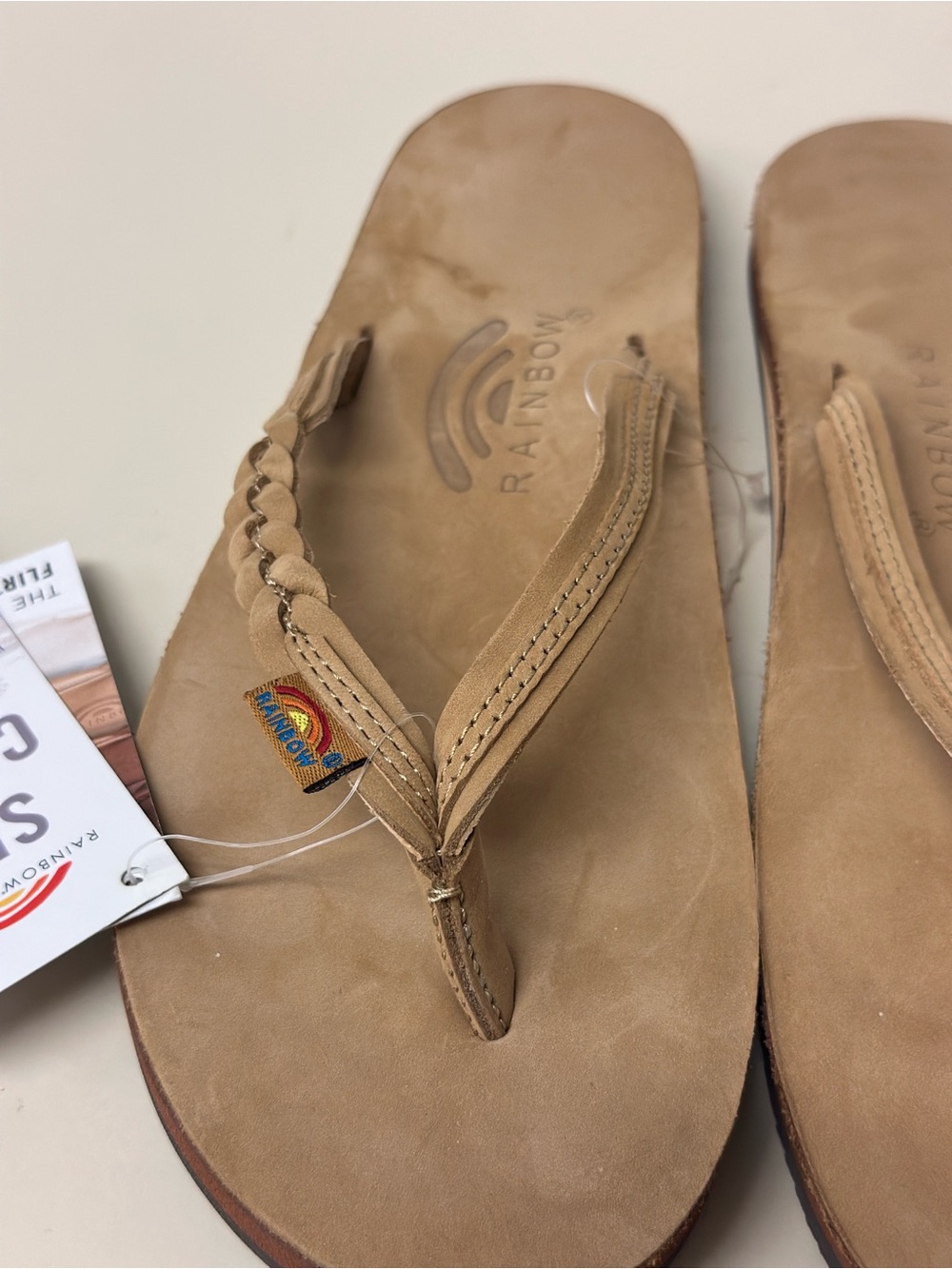 Rainbow Flirty Braided Strap Leather Flip Flops in Tan